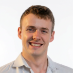 Baker-Thomas-Headshot-without-Background-e1779057806615.png